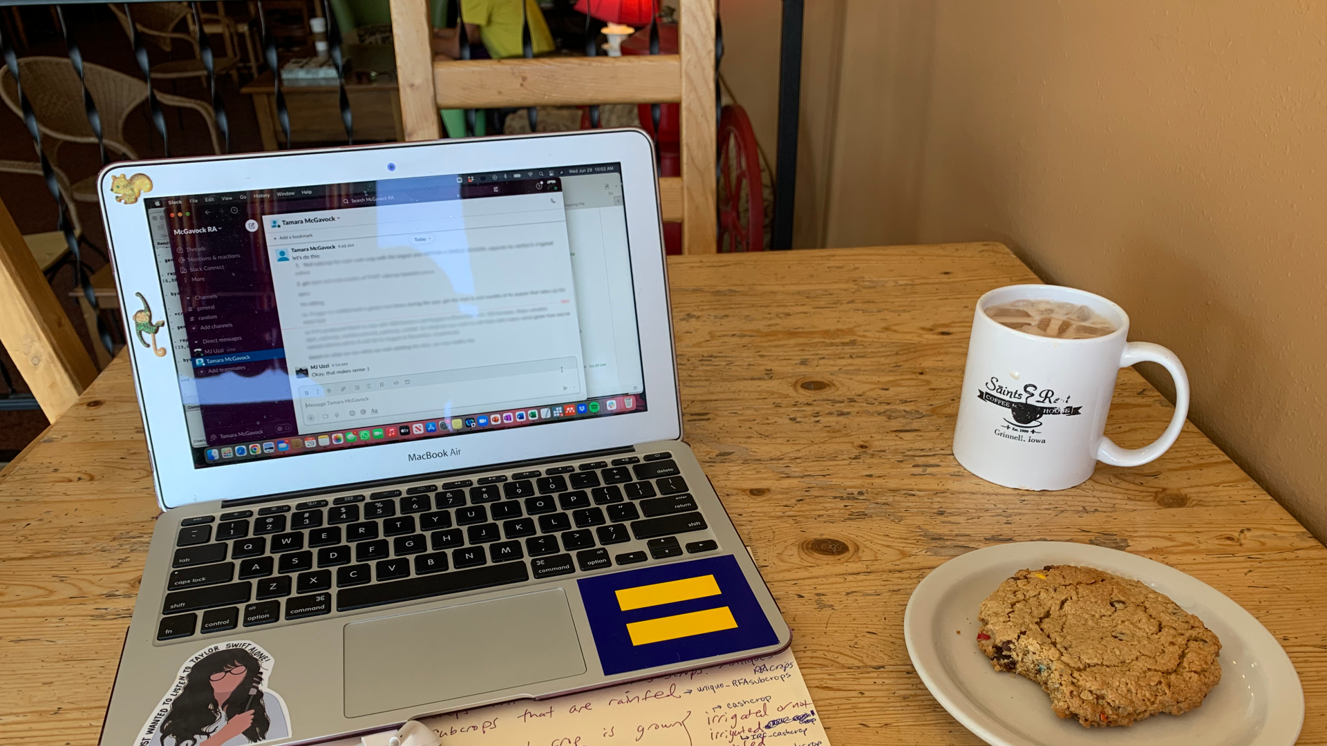 An open laptop with a cookie and Saints Rest coffee mug to the right of the laptop. On the laptop, Professor McGavock gives instructions to me. I say "okay, that makes sense :)"